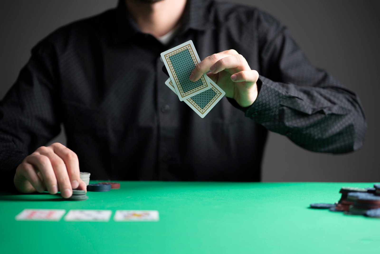 poker player in the casino playing a game and holding cards